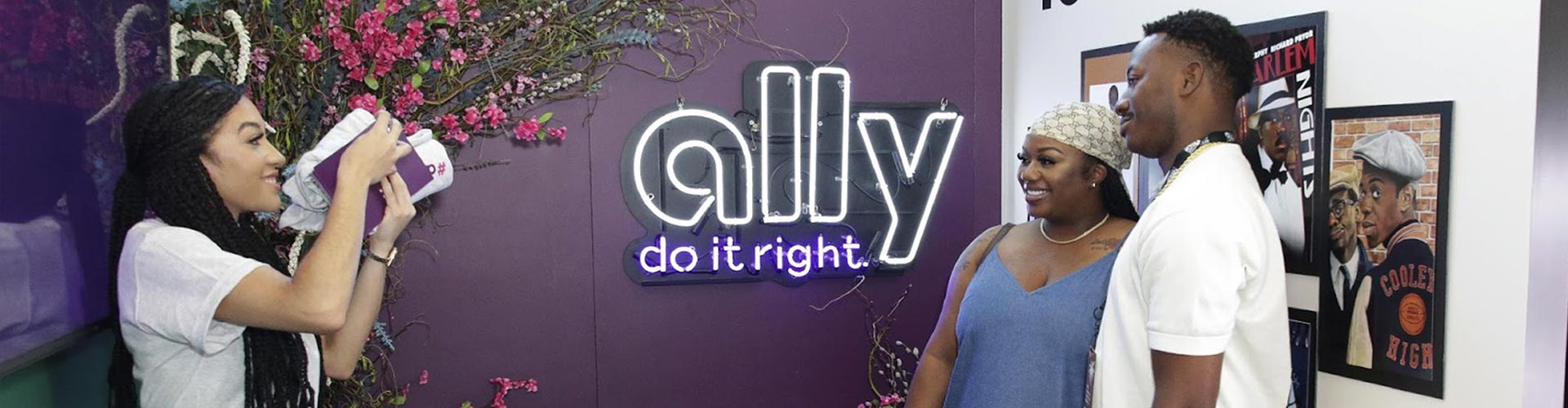 Guests having their photo taken at the Ally sponsor exhibit